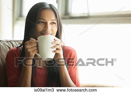 Woman having coffee at home View Large Photo Image Stock Image - Woman having coffee at home. Fotosearch