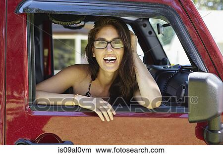 Picture - Woman leaning out of car window. Fotosearch