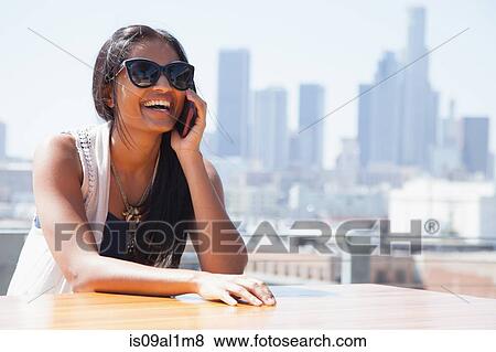 Woman on smartphone, skyscrapers in background View Large Photo Image Stock Photo - Woman on smartphone, skyscrapers in background. Fotosearch
