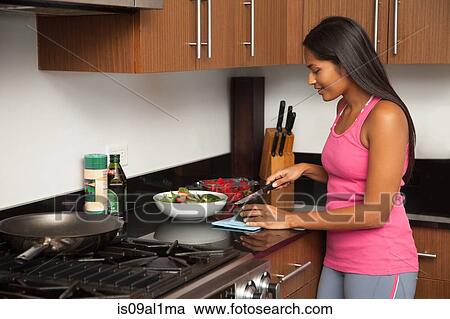 Woman preparing salad in kitchen View Large Photo Image Stock Image - Woman preparing salad in kitchen. Fotosearch