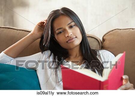 Stock Photo - Woman reading book at home. Fotosearch