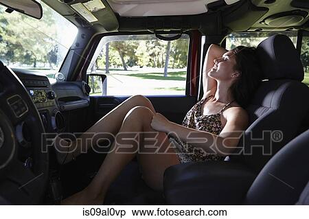 Stock Photography - Woman relaxing in car. Fotosearch