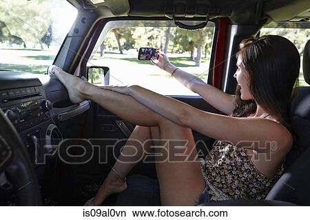Woman taking selfie in car View Large Photo Image Picture - Woman taking selfie in car. Fotosearch