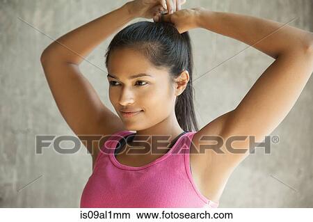 Woman tying up hair View Large Photo Image Picture - Woman tying up hair. Fotosearch