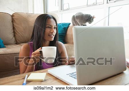 Stock Image - Woman using laptop at home. Fotosearch