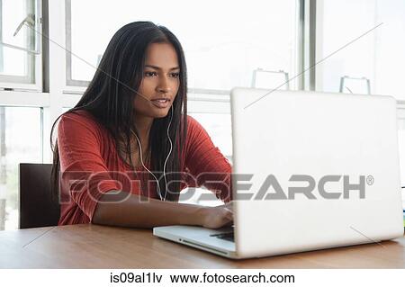 Stock Photo - Woman using laptop at home. Fotosearch