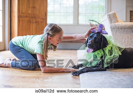 Young girl playing dress up with pet dog View Large Photo Image Stock Image - Young girl playing dress up with pet dog. Fotosearch