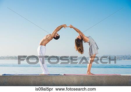 Young man and woman doing yoga at Pacific beach, San Diego, California, USA View Large Photo Image Stock Photography - Young man and woman doing yoga at Pacific beach, San Diego, California, USA. Fotosearch