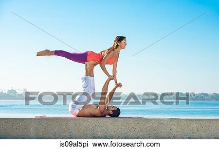 Young man and woman practicing yoga on pier at Pacific beach, San Diego, California, USA View Large Photo Image Stock Image - Young man and woman practicing yoga on pier at Pacific beach, San Diego, California, USA. Fotosearch