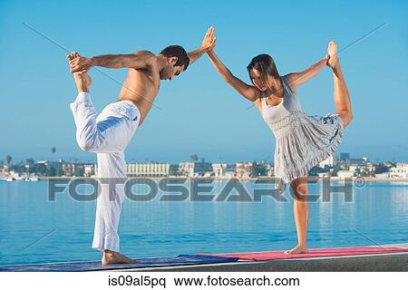 Young man and woman practicing yoga position at Pacific beach, San Diego, California, USA View Large Photo Image Stock Photography - Young man and woman practicing yoga position at Pacific beach, San Diego, California, USA. Fotosearch