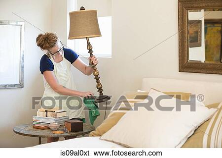 Young woman cleaning bedroom with green cleaning products View Large Photo Image Stock Photograph - Young woman cleaning bedroom with green cleaning products. Fotosearch