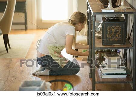 Stock Image - Young woman cleaning home with green cleaning products. Fotosearch