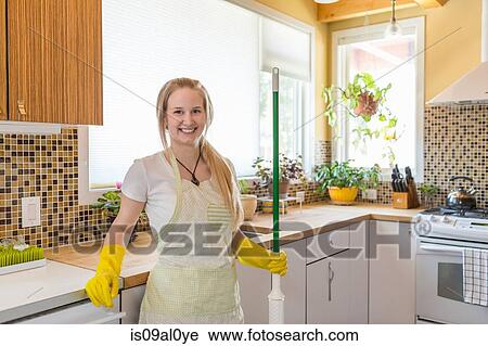 Young woman cleaning kitchen with green cleaning products View Large Photo Image Stock Image - Young woman cleaning kitchen with green cleaning products. Fotosearch