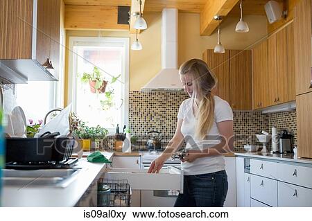Young woman cleaning kitchen with green cleaning products View Large Photo Image Stock Photo - Young woman cleaning kitchen with green cleaning products. Fotosearch