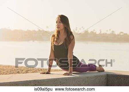 Young woman doing yoga on pier at Pacific beach, San Diego, California, USA View Large Photo Image Stock Photograph - Young woman doing yoga on pier at Pacific beach, San Diego, California, USA. Fotosearch