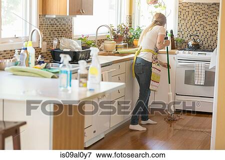 Stock Photo - Young woman mopping with green cleaning products. Fotosearch