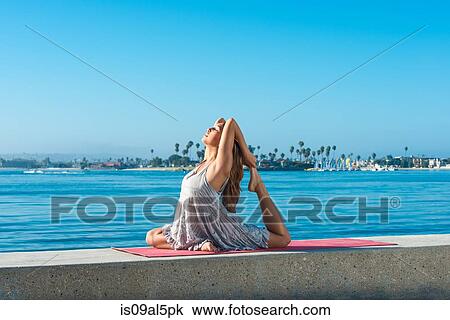Young woman practicing yoga position on pier at Pacific beach, San Diego, California, USA View Large Photo Image Stock Image - Young woman practicing yoga position on pier at Pacific beach, San Diego, California, USA. Fotosearch