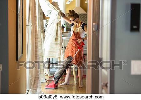 Young woman vacuuming with green cleaning products View Large Photo Image Stock Photo - Young woman vacuuming with green cleaning products. Fotosearch