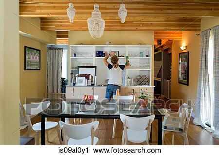 Stock Image - Young women cleaning home with green cleaning products. Fotosearch