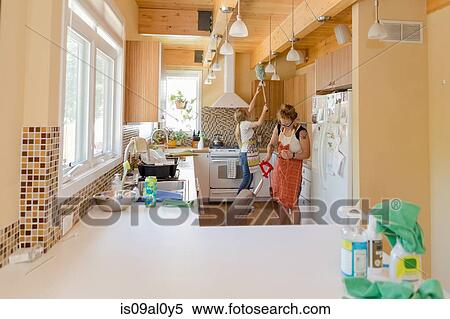Young women cleaning kitchen with green cleaning products View Large Photo Image Stock Photography - Young women cleaning kitchen with green cleaning products. Fotosearch