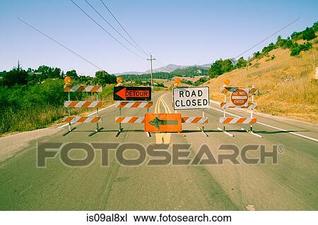 Stock Image - A row of road closed signs across highway. Fotosearch