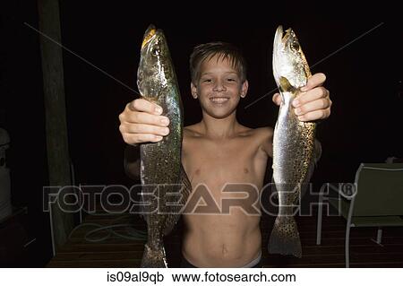 Boy at night holding up two spanish mackerel fish, Shalimar, Florida, USA View Large Photo Image Stock Image - Boy at night holding up two spanish mackerel fish, Shalimar, Florida, USA. Fotosearch