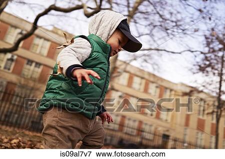 Boy playing in park, Brooklyn, New York, USA View Large Photo Image Stock Photo - Boy playing in park, Brooklyn, New York, USA. Fotosearch