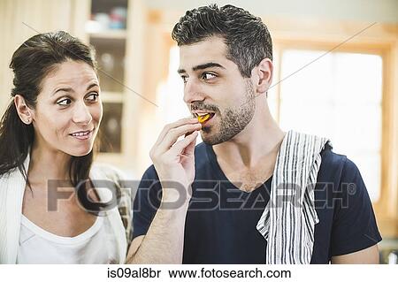 Couple chatting and eating in kitchen View Large Photo Image Stock Photography - Couple chatting and eating in kitchen. Fotosearch