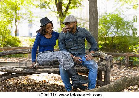 Couple chatting on bench View Large Photo Image Stock Photography - Couple chatting on bench. Fotosearch
