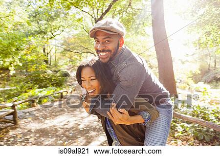 Couple playing piggy back, Central Park, New York, USA View Large Photo Image Stock Image - Couple playing piggy back, Central Park, New York, USA. Fotosearch