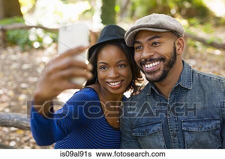 Couple taking selfie View Large Photo Image Stock Photograph - Couple taking selfie. Fotosearch