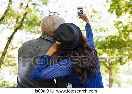 Stock Photograph - Couple taking selfie. Fotosearch