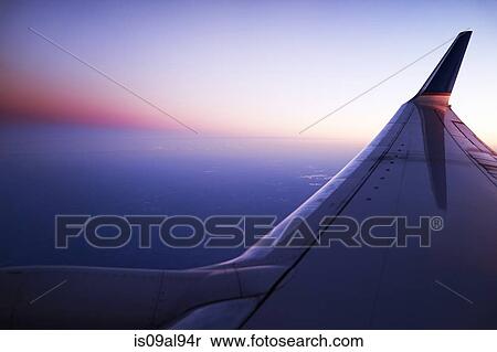 Elevated view of airplane wing and sky at sunset View Large Photo Image Stock Photography - Elevated view of airplane wing and sky at sunset. Fotosearch