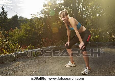 Exhausted female runner taking a break in park View Large Photo Image Stock Photography - Exhausted female runner taking a break in park. Fotosearch