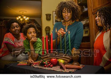 Family lighting kinara candles, celebrating Kwanzaa View Large Photo Image Stock Photography - Family lighting kinara candles, celebrating Kwanzaa. Fotosearch
