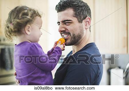 Father and daughter playing in kitchen View Large Photo Image Picture - Father and daughter playing in kitchen. Fotosearch