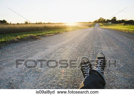 Feet of farmer traveling on rural road at dusk, Plattsburg, Missouri, USA View Large Photo Image Stock Image - Feet of farmer traveling on rural road at dusk, Plattsburg, Missouri, USA. Fotosearch