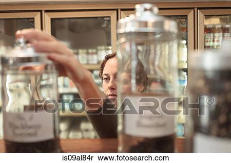 Female customer selecting jar from shelf in country store View Large Photo Image Stock Photography - Female customer selecting jar from shelf in country store. Fotosearch
