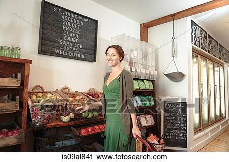 Stock Photograph - Female customer shopping in country store. Fotosearch