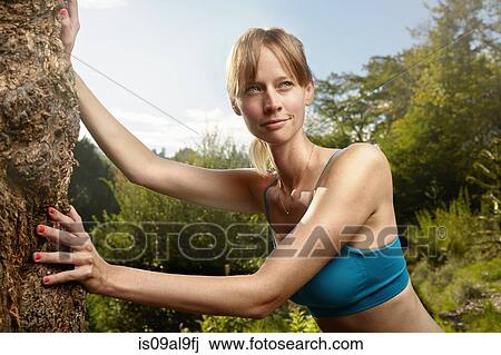 Female runner leaning against rock in park warming up View Large Photo Image Stock Image - Female runner leaning against rock in park warming up. Fotosearch