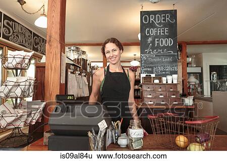 Female sales assistant checking out shopping in country store cafe View Large Photo Image Stock Photograph - Female sales assistant checking out shopping in country store cafe. Fotosearch