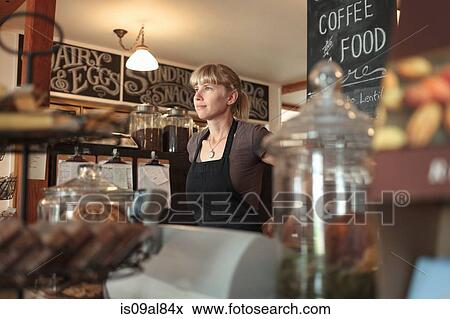 Female shop assistant in country store cafe View Large Photo Image Stock Photo - Female shop assistant in country store cafe. Fotosearch