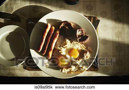 Fried breakfast of sausages, eggs and mushrooms on table View Large Photo Image Stock Image - Fried breakfast of sausages, eggs and mushrooms on table. Fotosearch