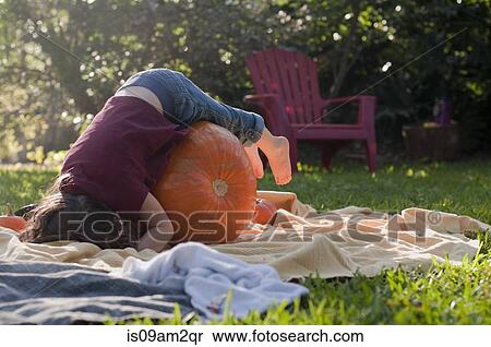 Stock Photography - Girl lying on pumpkin. Fotosearch