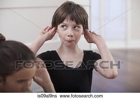 Girl with holding ears pulling a face in ballet school View Large Photo Image Stock Photograph - Girl with holding ears pulling a face in ballet school. Fotosearch