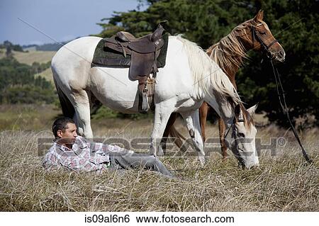 Horse rider taking break on grass, Pakiri Beach, Auckland, New Zealand View Large Photo Image Stock Photograph - Horse rider taking break on grass, Pakiri Beach, Auckland, New Zealand. Fotosearch