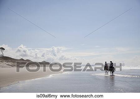Stock Photo - Horse riding, Pakiri Beach, Auckland, New Zealand. Fotosearch
