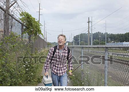Laughing fisherman walking along industrial path, Monroe, Michigan, USA View Large Photo Image Stock Image - Laughing fisherman walking along industrial path, Monroe, Michigan, USA. Fotosearch