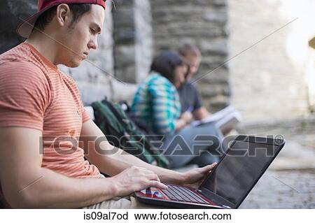 Male student using laptop View Large Photo Image Stock Image - Male student using laptop. Fotosearch