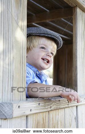 Male toddler in flat cap leaning out of shed window View Large Photo Image Stock Photography - Male toddler in flat cap leaning out of shed window. Fotosearch